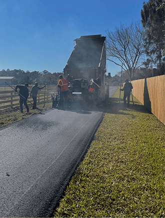 Workers paving a road